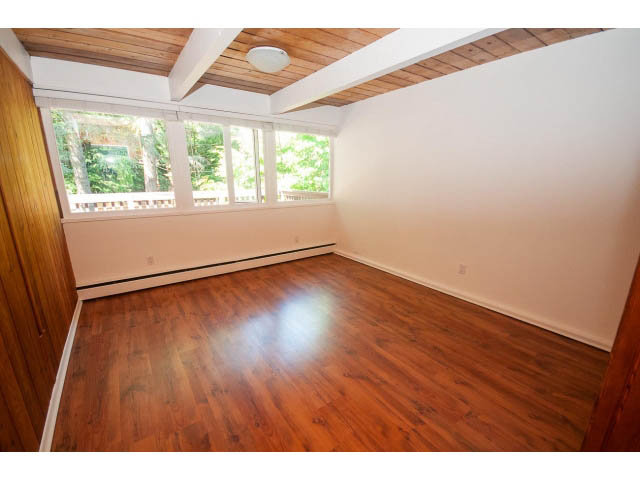 Bright living room with hardwood floors and large windows. - 640 East Queens Rd, North Vancouver