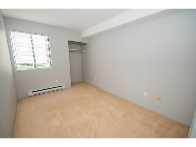 Bright bedroom with closet and window, carpeted floor. - 123 - 1363 Clyde Avenue, West Vancouver