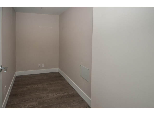 Den with hardwood floors and white walls. - 301 - 1783 Manitoba St, Vancouver West Side