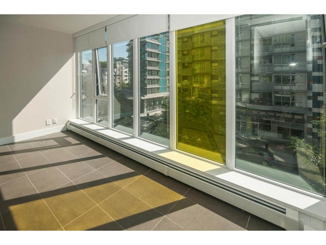 Furnished den with large windows, city view, and modern decor. - 301 - 1783 Manitoba St, Vancouver West Side