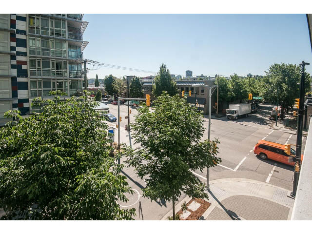 Bright living room with city view and modern furnishings. - 301 - 1783 Manitoba St, Vancouver West Side