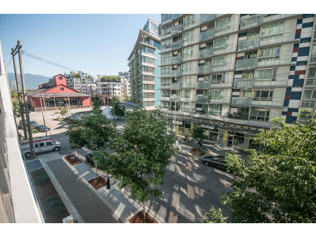 Bright living room with city view and modern furnishings. - 301 - 1783 Manitoba St, Vancouver West Side