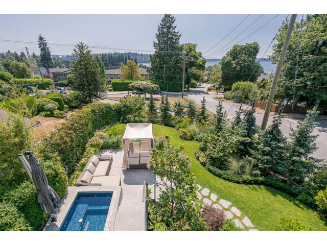 Spacious living room with a pool and lush greenery, overlooking a serene neighborhood. - Address WITHHELD, West Vancouver