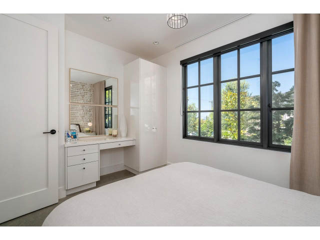 Bright bedroom with large windows, modern vanity, and city view. - Address WITHHELD, West Vancouver