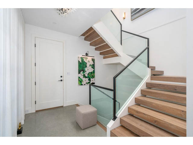 Bright entryway with modern staircase, glass railings, and white walls. - Address WITHHELD, West Vancouver