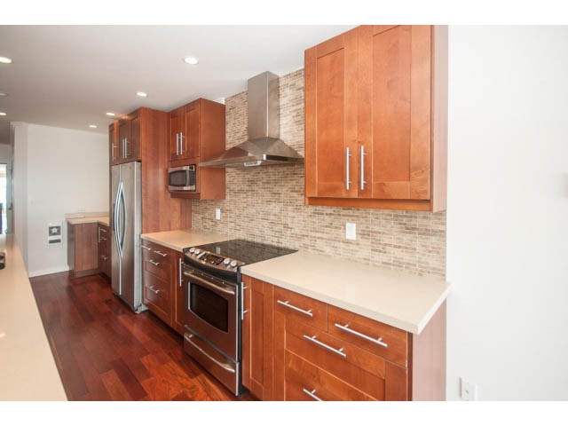 Bright kitchen with modern cabinetry, granite countertops, and hardwood floors. - 2150 Argyle Ave., West Vancouver