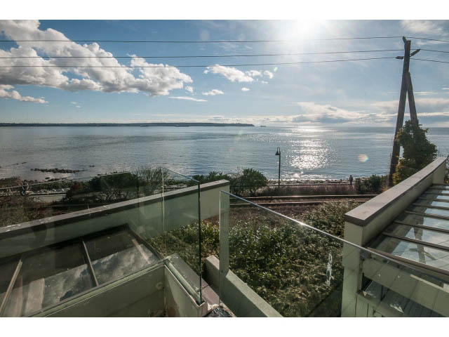 Bright living room with panoramic ocean view and glass railings. - 2150 Argyle Ave., West Vancouver