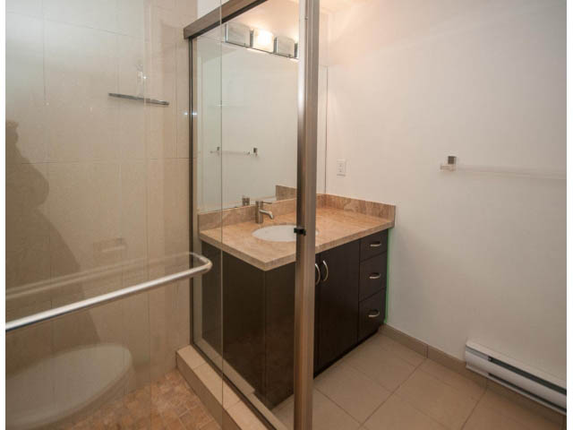 Bathroom with modern vanity, glass shower, and tile flooring. - 2150 Argyle Ave., West Vancouver