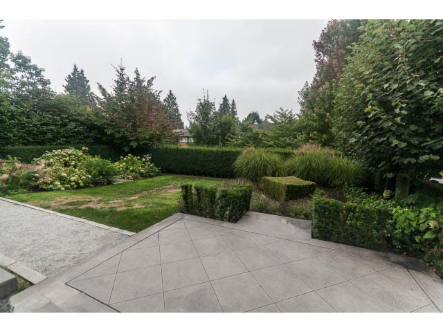 Spacious patio with stone tiles and lush greenery. - 5630 Angus Dr., Vancouver West Side