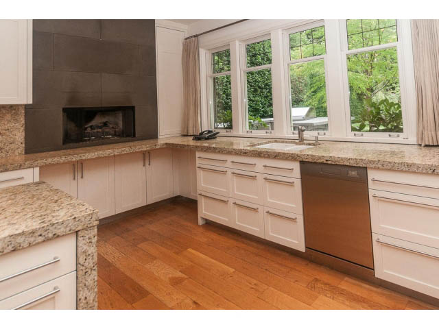 Bright kitchen with granite countertops, hardwood floors, and a large window view. - 5630 Angus Dr., Vancouver West Side