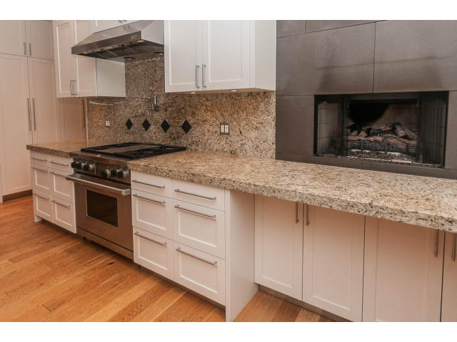 Bright kitchen with granite countertops, hardwood floors, and a built-in fireplace. - 5630 Angus Dr., Vancouver West Side