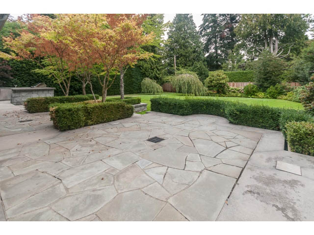 Spacious patio with flagstone flooring and manicured hedges. - 5630 Angus Dr., Vancouver West Side
