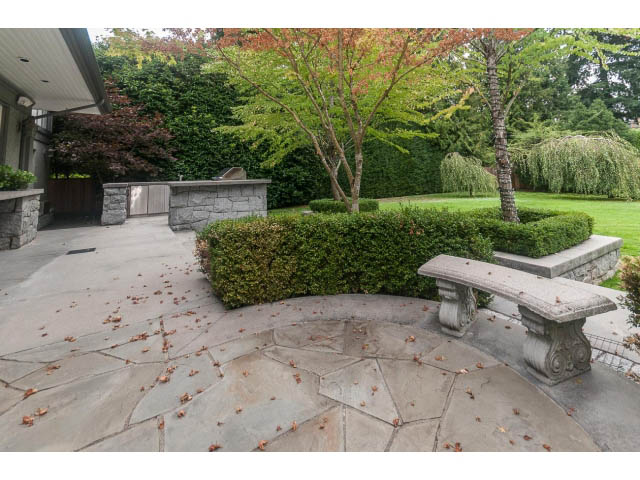 Spacious patio with stone flooring and lush greenery. - 5630 Angus Dr., Vancouver West Side