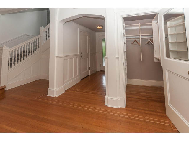 Furnished entryway with hardwood floors, white wainscoting, and a closet with hanging rods. - 5630 Angus Dr., Vancouver West Side