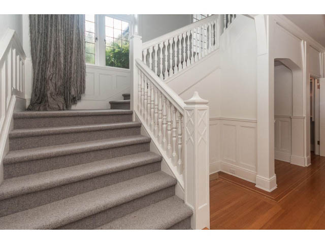 Staircase with white banister and carpeted steps leading to upper level. - 5630 Angus Dr., Vancouver West Side