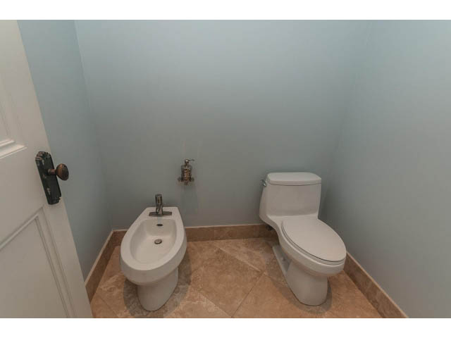 Bathroom with bidet and toilet, light blue walls, tiled floor. - 5630 Angus Dr., Vancouver West Side