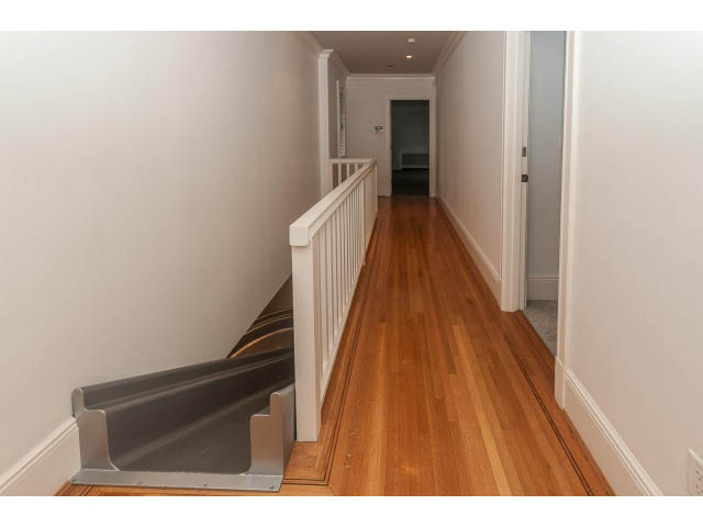 Furnished hallway with hardwood floors and white railings. - 5630 Angus Dr., Vancouver West Side