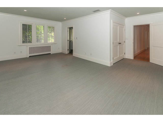 Empty living room with hardwood floors and large windows. - 5630 Angus Dr., Vancouver West Side