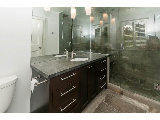 Bathroom with dark wood cabinets, granite countertops, and glass shower. - 5630 Angus Dr., Vancouver West Side