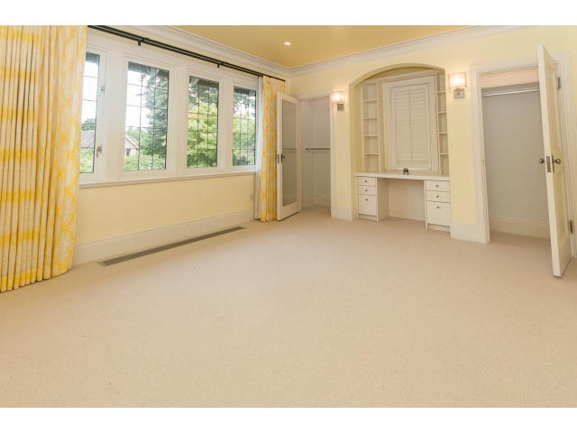 Bright bedroom with large windows, yellow curtains, and built-in desk. - 5630 Angus Dr., Vancouver West Side