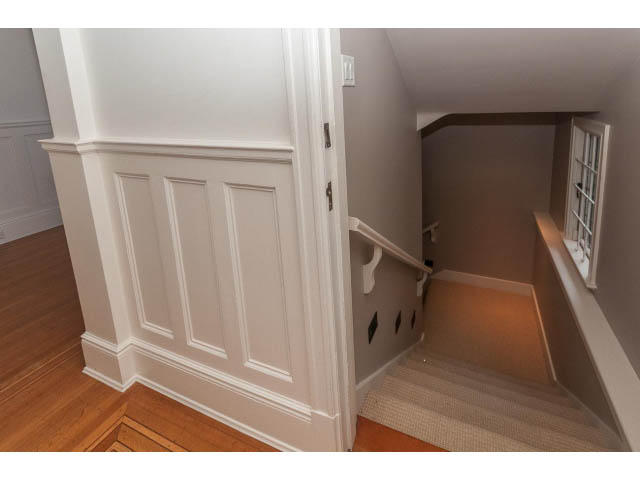 Staircase with wainscoting and hardwood floors leading to upper level. - 5630 Angus Dr., Vancouver West Side