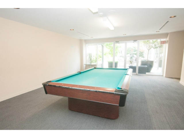 Bright living room with large windows and a pool table. - 1213 - 989 Nelson, Vancouver Downtown