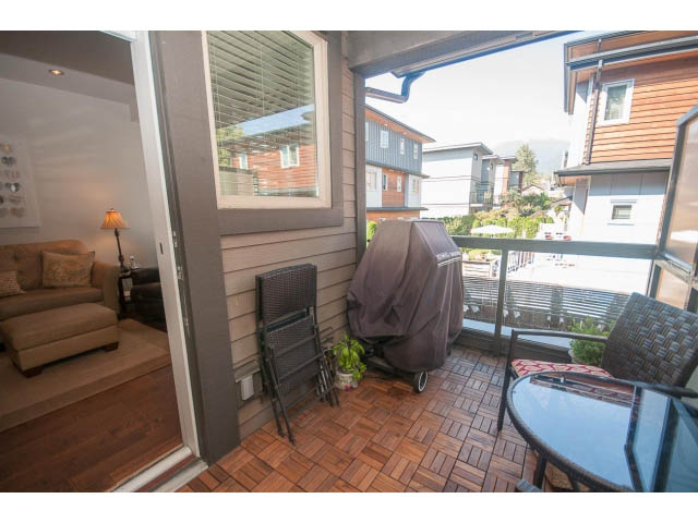 Furnished living room with hardwood floors and a view of the city. - 205 - 116 West 23rd, North Vancouver