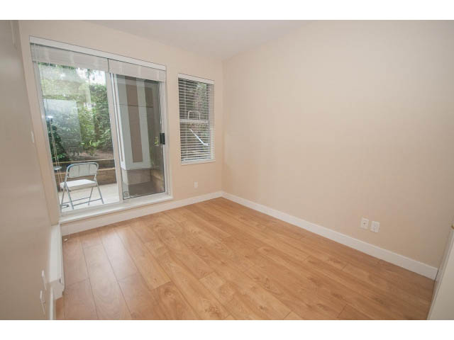 Bright den with hardwood floors and sliding glass door leading to patio. - 202 - 3629 Deercrest, North Vancouver
