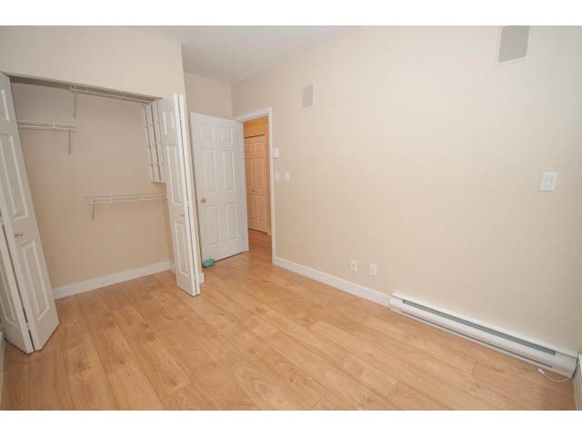 Bright bedroom with hardwood floors and closet space. - 202 - 3629 Deercrest, North Vancouver