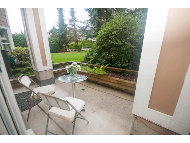 Furnished patio with outdoor furniture and garden view. - 202 - 3629 Deercrest, North Vancouver