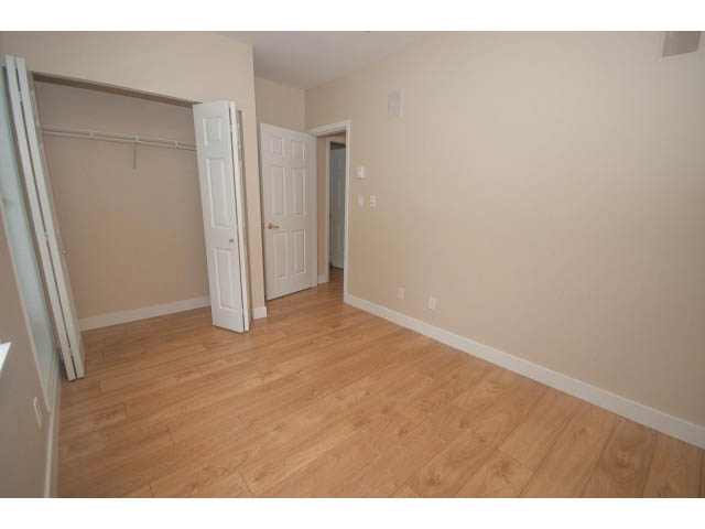 Bright living room with hardwood floors and a large closet. - 202 - 3629 Deercrest, North Vancouver