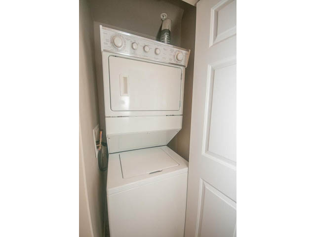 Bright laundry room with white appliances and a small window. - 202 - 3629 Deercrest, North Vancouver