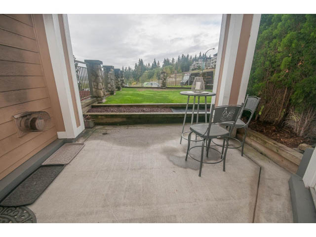 Furnished patio with outdoor furniture and scenic view of trees and grass. - 202 - 3629 Deercrest, North Vancouver
