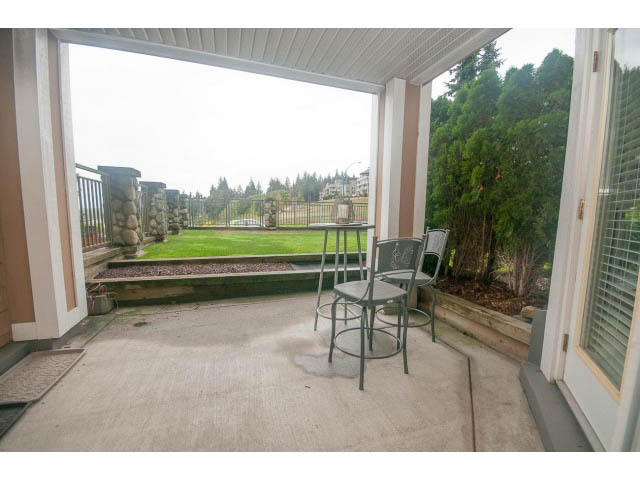 Furnished patio with outdoor furniture and a view of greenery. - 202 - 3629 Deercrest, North Vancouver