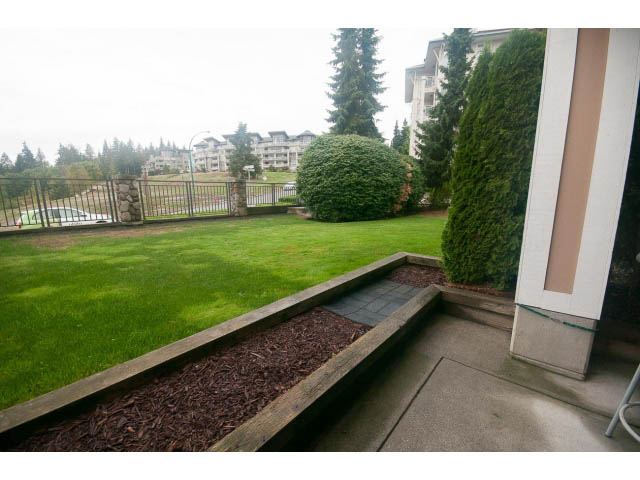 Furnished balcony with grassy area and city view. - 202 - 3629 Deercrest, North Vancouver