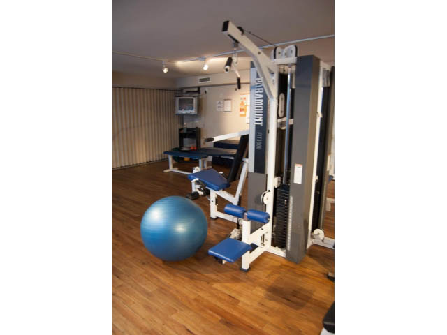 Fitness room with exercise equipment and hardwood floors. - 202 - 3629 Deercrest, North Vancouver