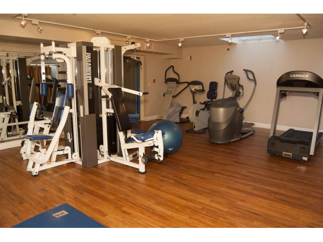 Bright gym with hardwood floors, exercise equipment, and mirrors. - 202 - 3629 Deercrest, North Vancouver