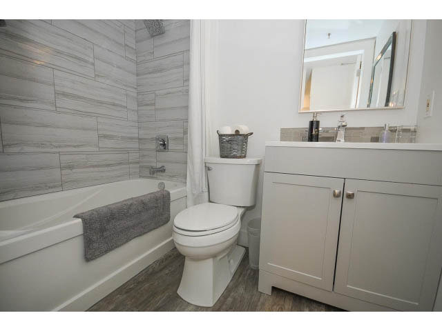 Furnished bathroom with white cabinets, gray marble-look tiles, and a modern sink setup. - 2102 - 1199 Seymour Street, Vancouver Downtown