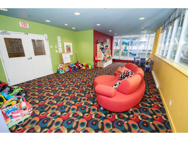 Furnished living room with colorful furniture and patterned carpet. - 2102 - 1199 Seymour Street, Vancouver Downtown