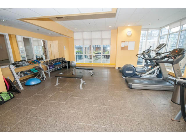 Spacious fitness room with cardio machines and large windows offering city views. - 2102 - 1199 Seymour Street, Vancouver Downtown