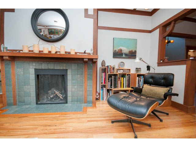 Living room with hardwood floors, modern furniture, and a large fireplace. - 1015 West 16th Ave, Vancouver West Side