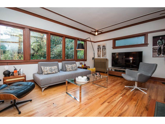 Spacious living room with hardwood floors, modern furniture, and large windows. - 1015 West 16th Ave, Vancouver West Side