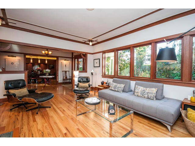 Spacious living room with hardwood floors, large windows, and modern furniture. - 1015 West 16th Ave, Vancouver West Side