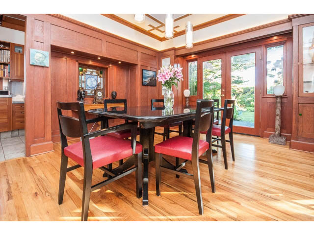 Furnished dining room with hardwood floors, red chairs, and a large window overlooking the garden. - 1015 West 16th Ave, Vancouver West Side