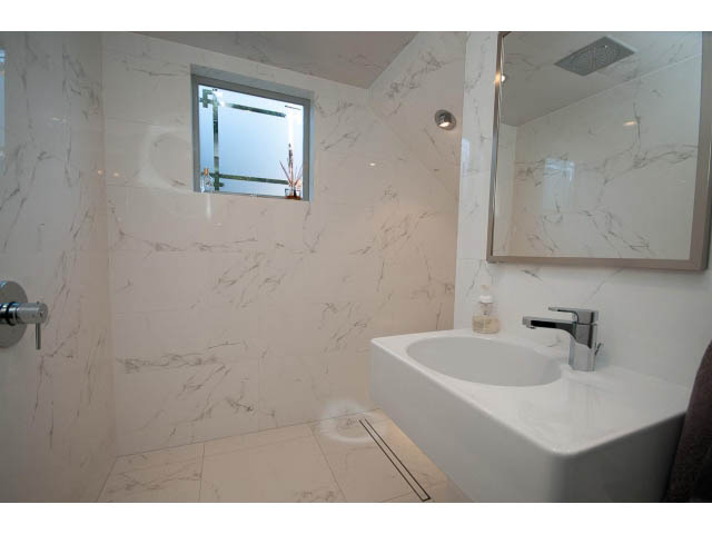 Spacious bathroom with marble countertops and a modern sink. - 1015 West 16th Ave, Vancouver West Side