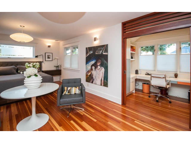Bright living room with hardwood floors, modern furniture, and a large window. - 1015 West 16th Ave, Vancouver West Side