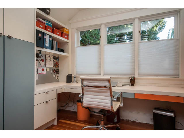 Bright home office with white countertops, hardwood floors, and large windows with blinds. - 1015 West 16th Ave, Vancouver West Side