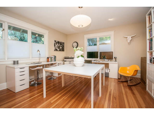 Bright and modern home office with white countertops, hardwood floors, and a city view. - 1015 West 16th Ave, Vancouver West Side