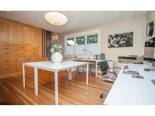 Bright living room with white countertops, hardwood floors, and a city view. - 1015 West 16th Ave, Vancouver West Side