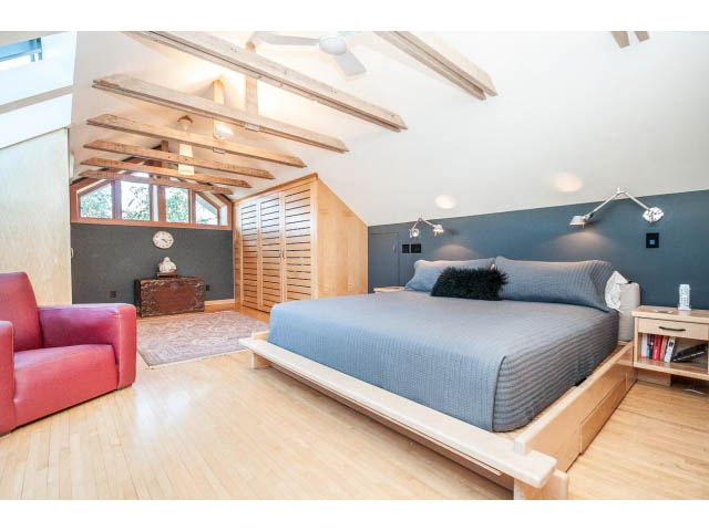 Spacious loft bedroom with exposed beams, hardwood floors, and a cozy reading nook. - 1015 West 16th Ave, Vancouver West Side